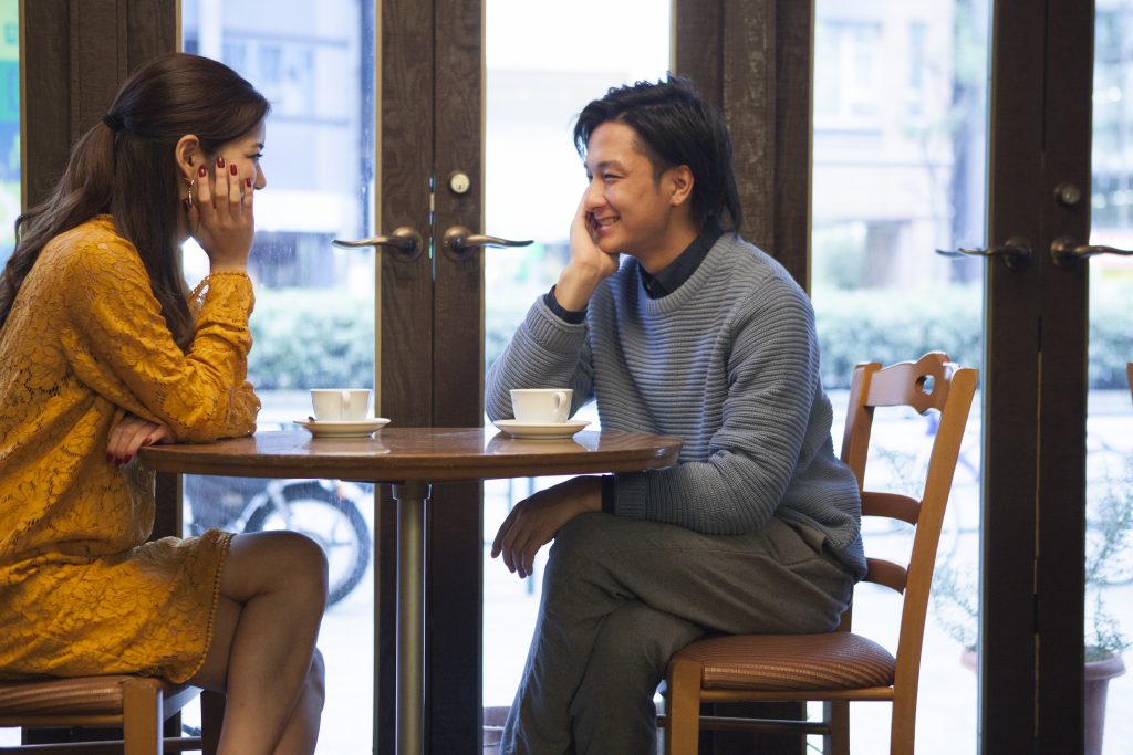The couple have each other staring at a cafe